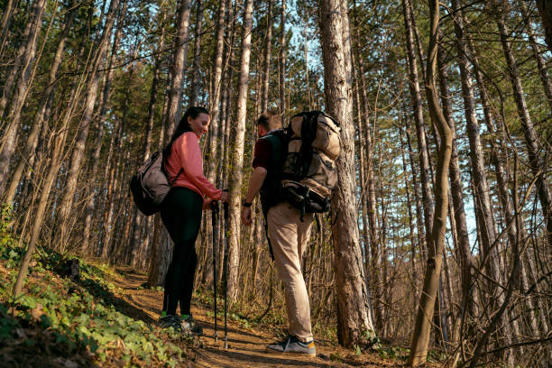 istock Young couple hiking together through the forest 1426393934