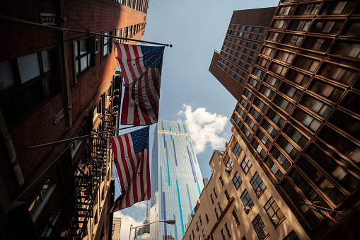 Low wide angle picturing two American flags on the wall of WeWork Office Space & Coworking at 311 W 43rd St, with The Westin New York Hotel building in the background, Manhattan, New York City, New York, July 26, 2013. (Photo by Agê Barros/Getty Images)