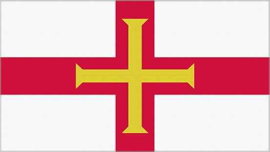 Guernsey embroidery flag. Emblem stitched fabric. Embroidered coat of arms. Country symbol textile background.
