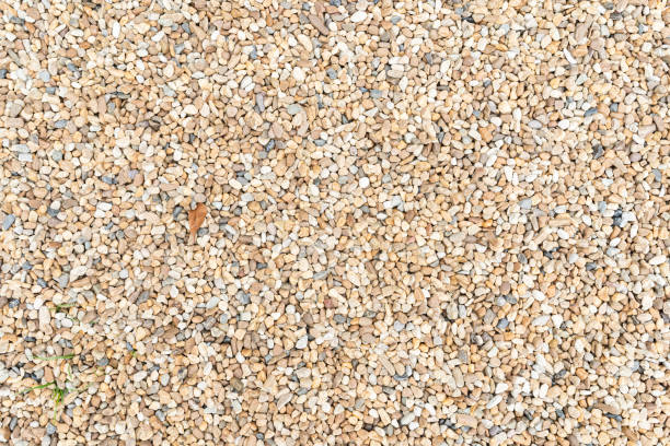 istock sand texture and stone pieces. Seamless texture. Small sea stones 1426406299