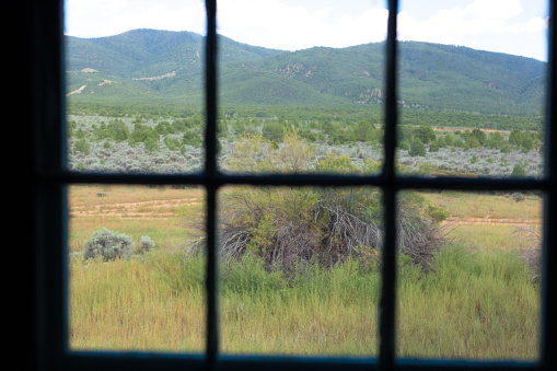 View Through Window: Taos Pueblo Prairie and Mountains. Shot in Taos, NM.