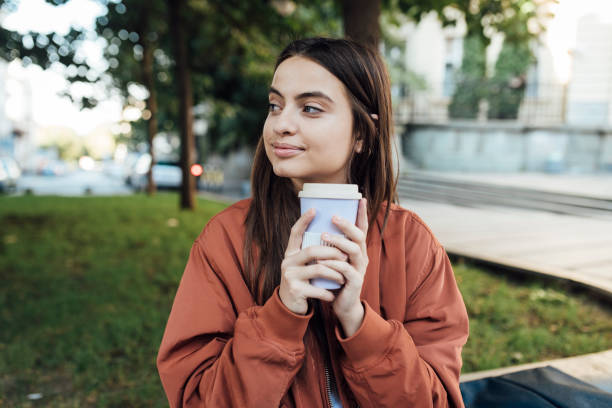 istock Girl holding coffee cup 1426408022