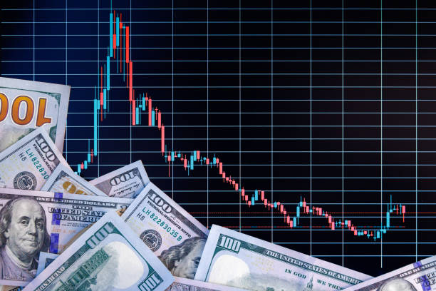istock US dollar banknote stacks over digital screen with exchange chart, depreciation and volatility concept, directly above view 1426408181