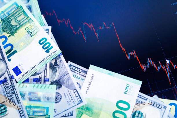 istock dollar and euro banknotes over digital screen with exchange chart, USD EUR parity concept 1426408185