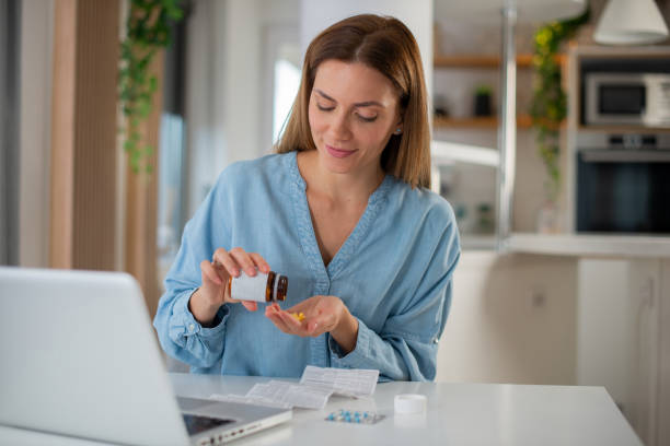 istock Young woman taking vitamins 1426409928