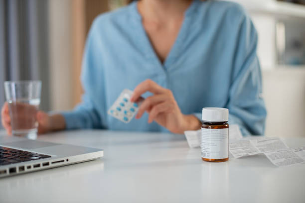 istock Young woman taking vitamins 1426409967