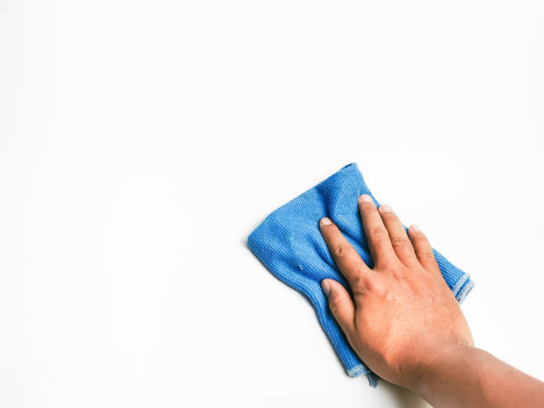 istock Hand holding blue microfiber cleaning cloth on white sufrace. 1426410538