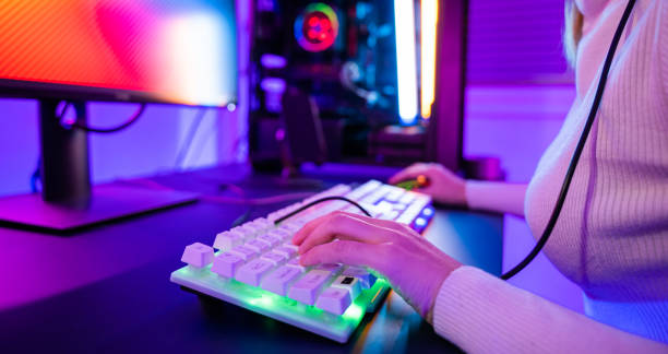 istock Close up gamer hands actively pushing buttons with colorful neon LED lights 1426410933