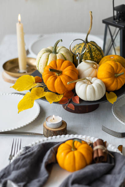 idea for a beautiful autumn setting for thanksgiving family dinner or wedding. orange pumpkin as decor. cozy fall home atmosphere. - autumn table setting flower imagens e fotografias de stock