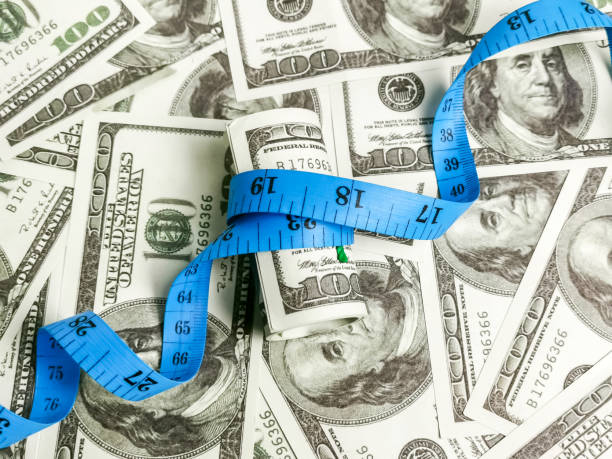 istock Dollar bank notes with measuring tape. 1426421880