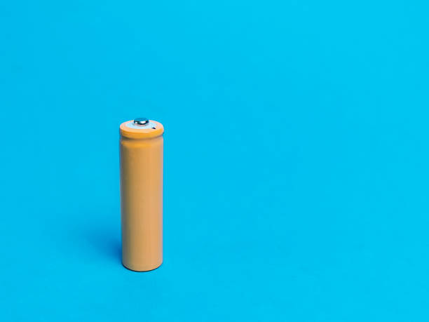 istock Rechargeable nicd AA size battery isolated on blue background. 1426426970