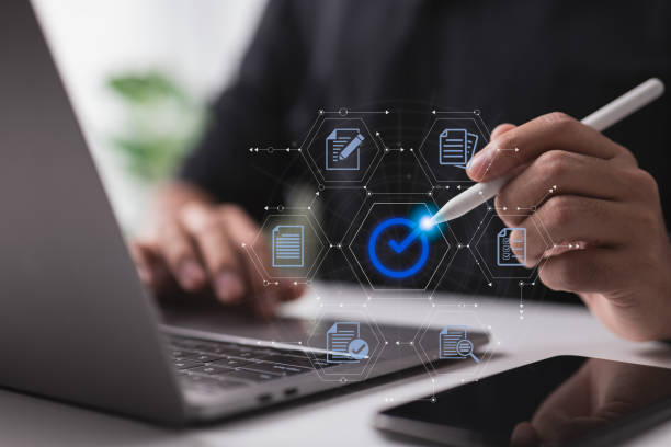 istock A businessman authenticates an electronic document by signing with a stylus pen on a digital tablet while using the proper sign. 1426427694