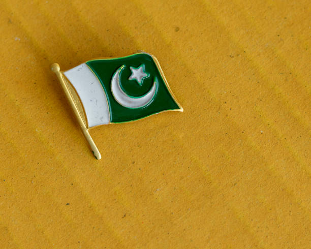 istock Pakistan flag gold metal badge with selective focus 1426430196