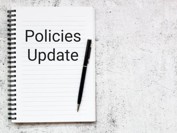istock Top view notebook with text policies update with a pen. 1426434336