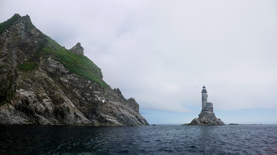 Sea of Okhotsk rocky coast and Aniva lighthouse, most southernmost point of Sakhalin island panoramic view