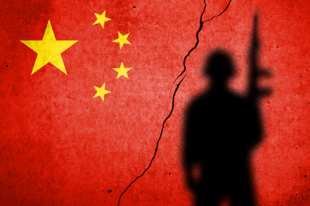 Flag of China painted on a cracked wall with soldier shadow stock photo