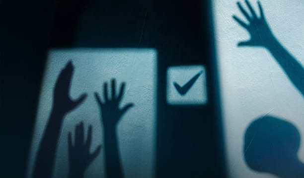 Freedom, Expression and Voting Concept. Shadow of Diversity People Rasing Hands Up for Express Human Power and Rights. shadow Shading on the Wall stock photo
