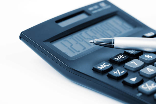 Calculator and Pen On White Background