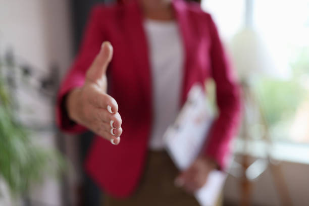 Closeup of woman hand reaching out for greeting in office stock photo