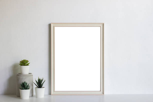 istock A white photo frame with cactus with natural light. 1426449253
