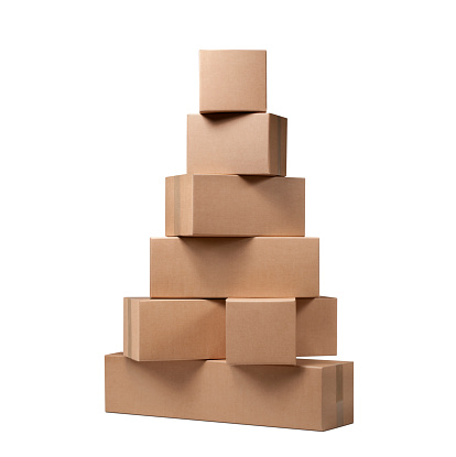 Stack of cardboard boxes in the shape of a Christmas tree isolated on white background.