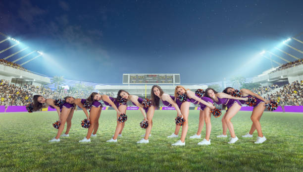 istock Group of cheerleaders in action on  stadium in night 1426457615