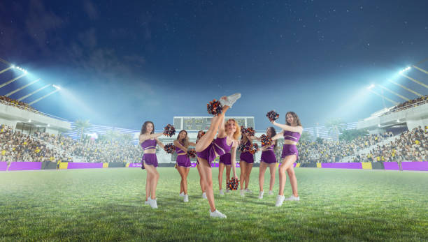 istock Group of cheerleaders in action on  stadium in night 1426457654