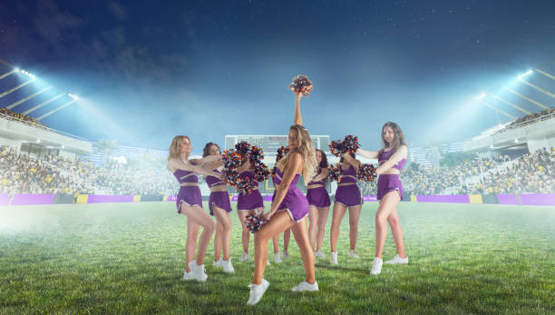 istock Group of cheerleaders in action on  stadium in night 1426457699