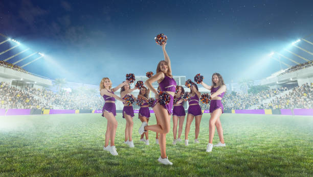 istock Group of cheerleaders in action on  stadium in night 1426457732