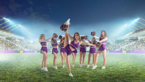 istock Group of cheerleaders in action on  stadium in night 1426457743