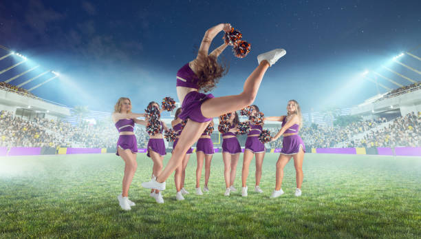 istock Group of cheerleaders in action on  stadium in night 1426457757