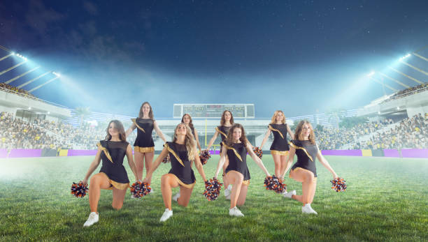 istock Group of cheerleaders in action on  stadium in night 1426457861