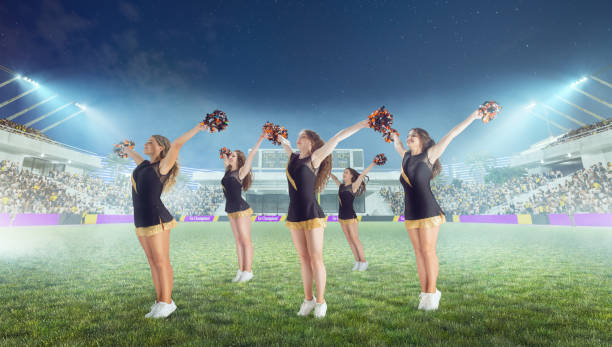 istock Group of cheerleaders in action on  stadium in night 1426457920