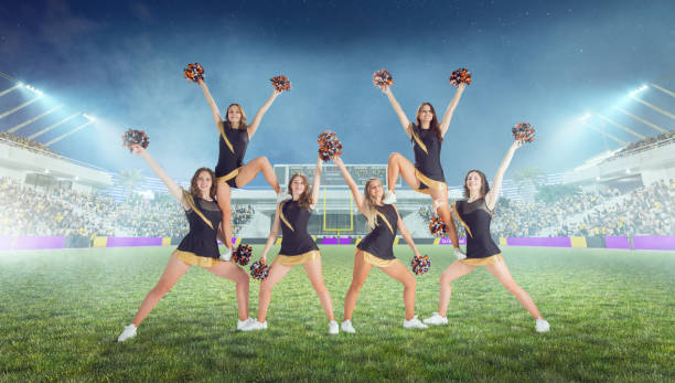 istock Group of cheerleaders in action on  stadium in night 1426457921