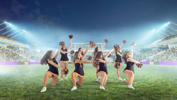 istock Group of cheerleaders in action on  stadium in night 1426457922