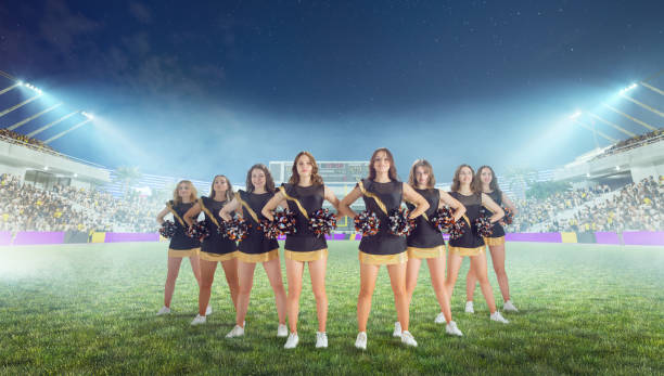 istock Group of cheerleaders in action on  stadium in night 1426457965