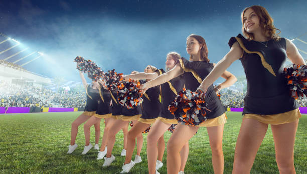 istock Group of cheerleaders in action on  stadium in night 1426459149