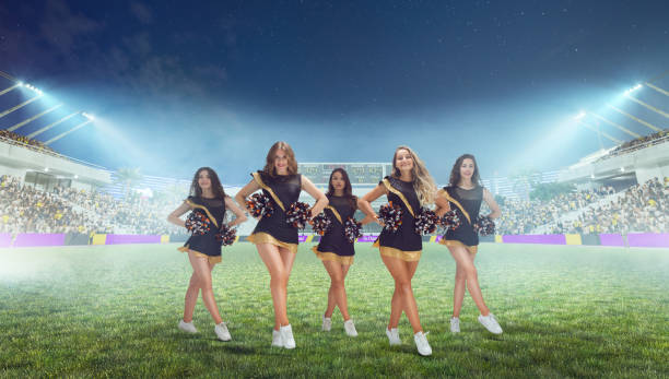 istock Group of cheerleaders in action on  stadium in night 1426459152