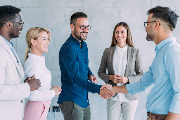 Successful partnership Business people shaking hands in the office. Business persons handshaking during a meeting in modern office. business relationship stock pictures, royalty-free photos & images