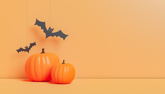 3D rendering of artificial bats hanging over orange pumpkins placed on bright table during Halloween celebration