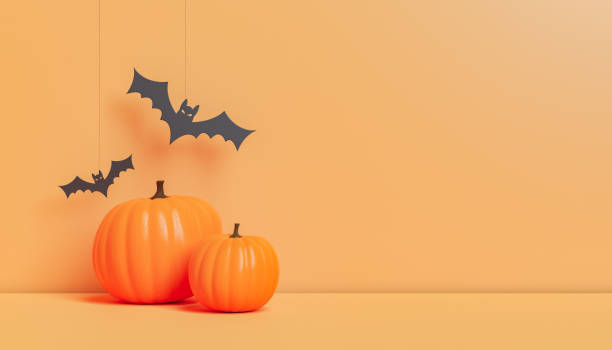 Halloween decorations with pumpkins and paper bats in studio stock photo
