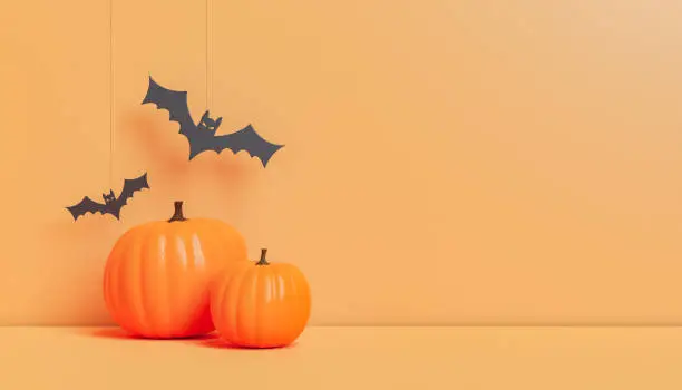 Photo of Halloween decorations with pumpkins and paper bats in studio