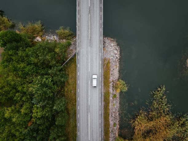istock Lonely car driving on road in countryside 1426462542