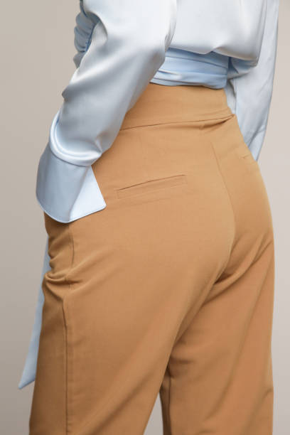 istock Studio photos of young female model wearing beige smart casual basic trousers 1426467528