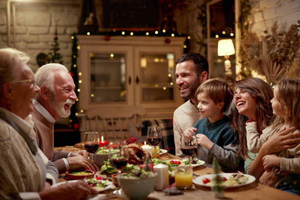 istock Happy extended family talking during lunch in dining room. 1426469511