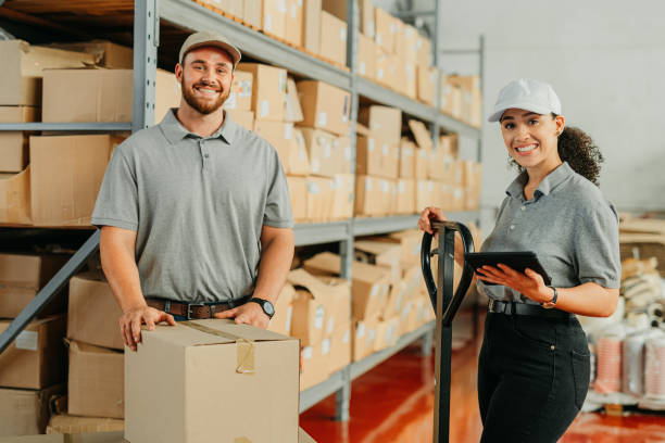 istock Delivery, factory or warehouse workers working together for shipping a cargo package on an ecommerce app on a tablet. Supply chain or logistics manager and a courier employee packing stock 1426469531