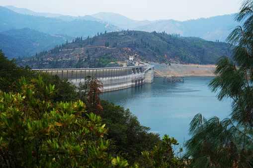 Landscape with the Amadorio reservoir dam in Orxeta and low water level due to climate change, Spain