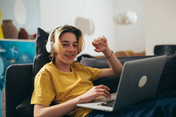 teenage boy at home teenager using laptop for video chatting from home one teenage boy only stock pictures, royalty-free photos & images