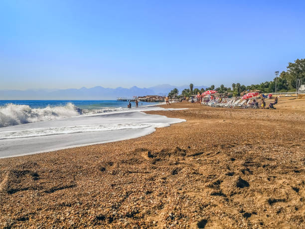 Antalya, Turkey - October 26, 2019: Big waves at Lara Beach in Antalya. Beautiful beach with yellow coarse sand on the Mediterranean Sea in the Turkish Riviera