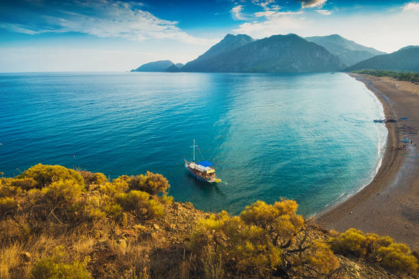 View from above to Cirali beach and Olimpos View from above to Cirali beach and Olimpos mountain in a sunset light. Kemer, Antalya, Mediterranean region, Turkey, Lycia. cirali stock pictures, royalty-free photos & images